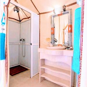 a bathroom with a sink and a shower at Magic Luxury Camp in Merzouga