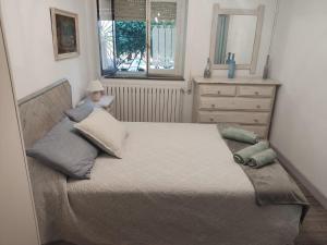 a bedroom with a bed with a doll sitting on it at Casa Roiz in Santillana del Mar