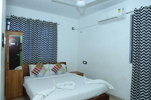 a bedroom with two beds and a mirror at Airport Cochin Grand Residency , NEDUMBASSERY in Angamali