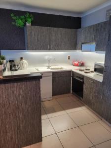 a kitchen with a sink and a counter top at Beach Palace in Middelkerke