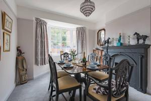 a dining room with a table and a fireplace at 19th Hole in Sandwich