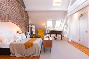 a bedroom with a bed and a brick wall at George Street - Irish Stay Group in Dublin