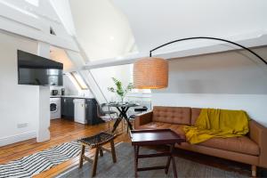 a living room with a couch and a table at George Street - Irish Stay Group in Dublin