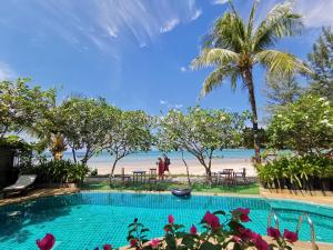 a swimming pool with a view of the beach at Layalina Hotel in Kamala Beach