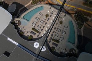 an overhead view of a parking lot with two pools at 2202 Oceans Apartment - by Stay in Umhlanga in Durban