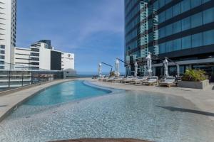 a swimming pool on the side of a building at 2202 Oceans Apartment - by Stay in Umhlanga in Durban