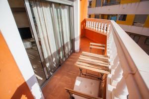 a balcony with a wooden bench and a staircase at PISO SAN ISIDRO (ALICANTE) in Alicante