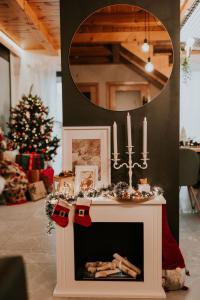 a fireplace in a living room with a christmas tree at The View House Rabka-Zdrój WELLNESS & SPA in Rabka