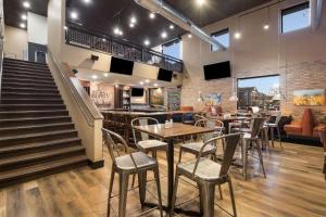 a restaurant with tables and chairs and stairs at Rodeway Inn Fort Morgan in Fort Morgan