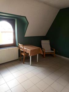 a room with a table and a chair and a window at Studio with city view at Saint Nicolas in Ans