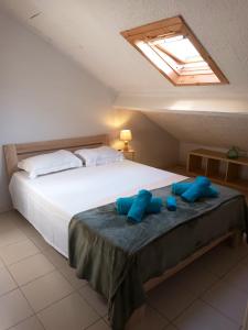 a bedroom with a large bed with two blue pillows at Studio with city view at Saint Nicolas in Ans
