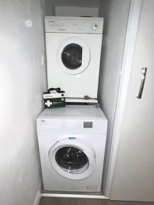 a washer and dryer in a small room at Newly renovated 1 bedroom flat with garden pergola in Ennis