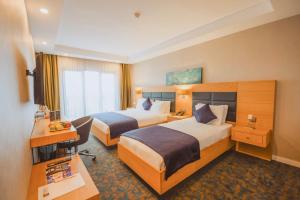 Ένα ή περισσότερα κρεβάτια σε δωμάτιο στο Sera Nature Hotel & Spa