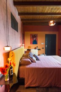 a bedroom with a bed and a table with flowers on it at Tenuta Pezzapane in Alvignanello