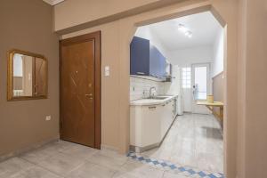 an empty kitchen with a sink and a door at Pegasus Apartment in Piraeus