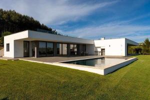 Bairro do Lobo的住宿－Casa Barbónica piscina privada，一座白色的房子,在庭院里设有一个游泳池