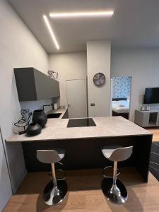a kitchen with two bar stools and a counter top at GLI EQUILIBRISTI in Cuneo