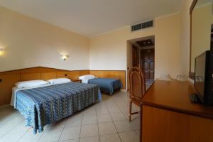 Postel nebo postele na pokoji v ubytování Villaggio Torre Ruffa Robinson