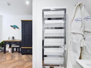 a book shelf in a room with a desk at Driftwood Boutique Guest House in Rhosneigr