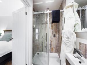 a bathroom with a shower and a sink at Driftwood Boutique Guest House in Rhosneigr