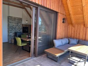 a patio with a couch and a table and a tablektop at Ferienwohnungen Lichtenegger in Kamp
