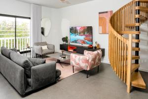 a living room with a couch and a tv at New Duplex 3 Bedroom with Jacuzzi in Tel Aviv