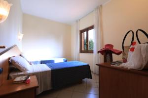 Postel nebo postele na pokoji v ubytování Villaggio Torre Ruffa Robinson