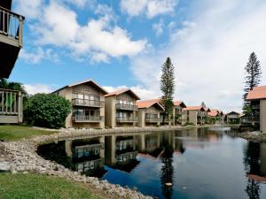 a row of apartment buildings next to a river at Our House at the Beach 222, Sleeps 4, 2 Bedroom, Tennis, Heated Pool in Siesta Key