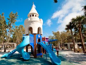 a playground with slides in front of a tower at Our House at the Beach 222, Sleeps 4, 2 Bedroom, Tennis, Heated Pool in Siesta Key