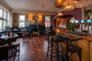 a bar in a restaurant with a fireplace at The Rising Sun in Backwell