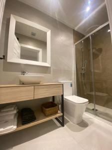 a bathroom with a sink and a toilet and a shower at La Posada de San Miguel in Andújar