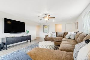 a living room with a couch and a flat screen tv at Grandma Buddy's House in Garden City