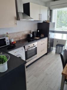a kitchen with a stove and a stove top oven at Apartment in TOP Lage Durlacher Tor/KIT in Karlsruhe