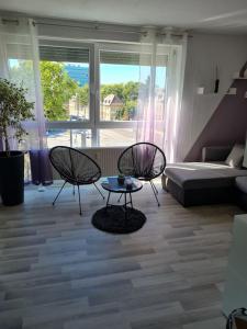 uma sala de estar com duas cadeiras, uma mesa e uma cama em Apartment in TOP Lage Durlacher Tor/KIT em Karlsruhe