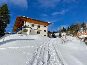 a building in the snow with tracks in the snow at Haus Plattenkar in Obertauern