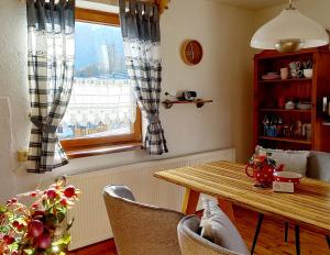 a dining room with a table and a window at Haus Moni in Bad Goisern