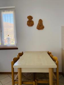 a table and chairs in a room with a window at La Rocchetta, Borgo Valsugana in Borgo