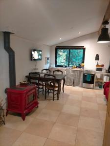 a kitchen and dining room with a table and chairs at appartement meublé sur la route de Compostelle ! in Aire-sur-lʼAdour