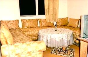 a living room with a couch and a table at Appartment Jamila a Agadir in Agadir