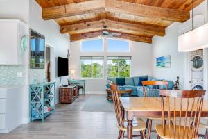 a dining room and living room with a wooden ceiling at Two White Turtles in Islamorada