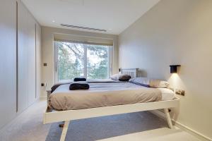 a bedroom with a large bed with a window at Luxury 3 bed flat with large terrace, sea views and hot tub in Canford Cliffs