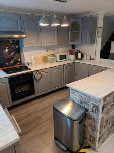 a kitchen with blue cabinets and a counter top at Luxurious 4 bed adorable house in Willington in Willington