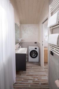 a bathroom with a washing machine and a sink at Elegance Riccione in Riccione