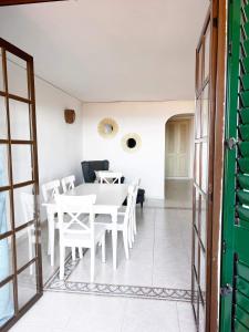 a dining room with a white table and chairs at Luxury Apartments Mascarat in Altea