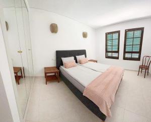 a bedroom with a bed and a glass shower at Luxury Apartments Mascarat in Altea
