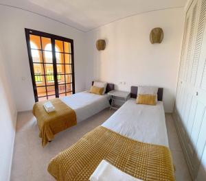 a bedroom with two beds and a window at Luxury Apartments Mascarat in Altea
