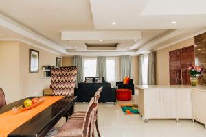 a living room with a couch and a table at Gosheni Villas in White River