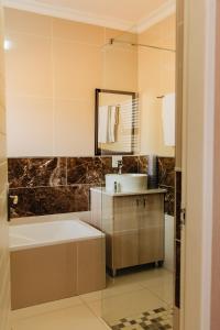 a bathroom with a sink and a mirror at Gosheni Villas in White River
