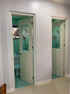 a bathroom with a toilet and a mirror at Entire Island home with Starlink and gated parking in Dapa