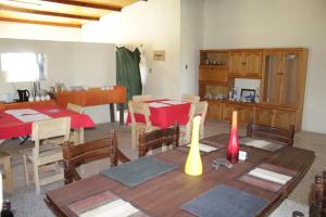 a dining room with a table and chairs and a kitchen at Bambi Lodge in Groutfontein